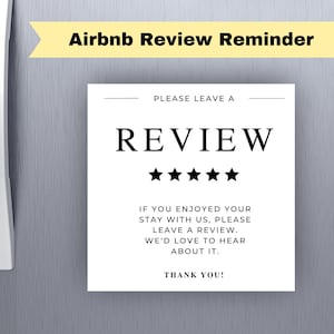May include: A white sign with the text "Airbnb Review Reminder" at the top. The sign says "REVIEW" with five stars below it. The sign asks guests to leave a review and thank them.