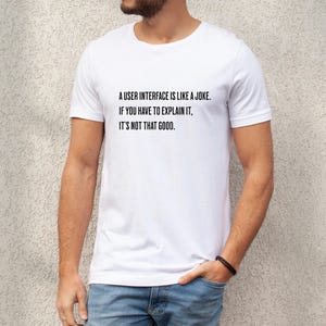 A man wearing a user interface coding shirt