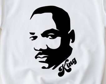 May include: White sweatshirt with a black silhouette of Martin Luther King Jr. and the word "King" in a retro font.
