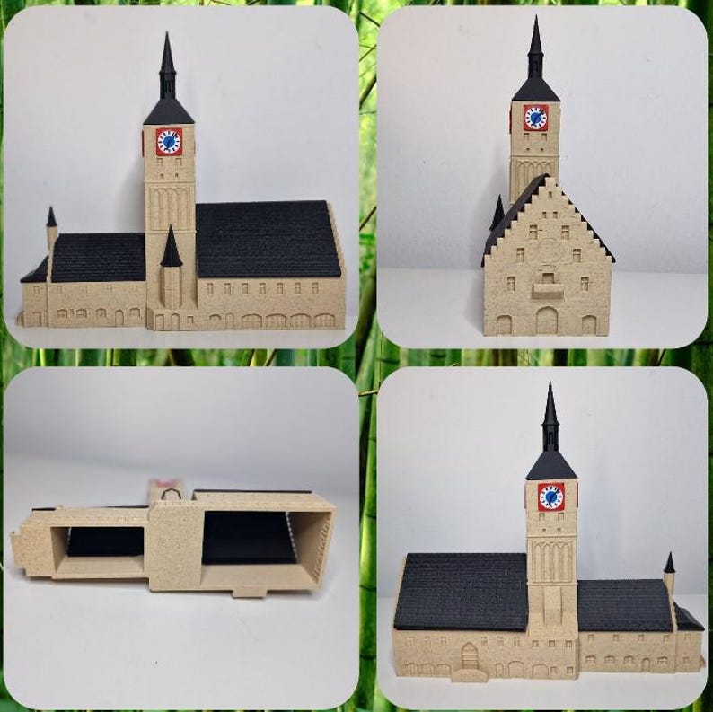 May include: A beige model of a church with a tall clock tower and a black roof. The clock face is red and blue. The model has detailed architectural features.