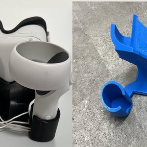 May include: A VR headset and controllers are displayed on a black and white stand. A separate blue stand is also shown. The VR headset is white and black, with white controllers. The blue stand is designed to hold the VR headset and controllers.