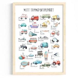 May include: Watercolor print of a transportation alphabet in a wooden frame. Each letter features a different vehicle, including an ambulance, fire truck, car, dump truck, and more. The text "MITT TRANSPORTALFABET" is at the top.