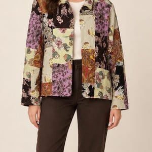 May include: A long-sleeve quilted jacket featuring a multi-colored patchwork design with floral and paisley patterns in shades of black, lavender, olive green, and rust. The jacket has a classic collar, a button-front closure, and a straight hemline.