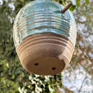 Blue Ceramic Birdhouse has drain holes in bottom