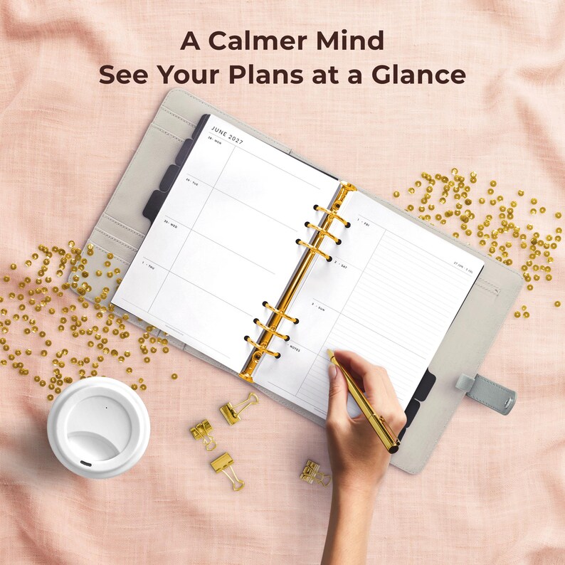 May include: An open six-ring planner with white pages showing June 2027, held in a light gray cover with gold hardware. A gold pen rests on the page. Text reads: A Calmer Mind, See Your Plans at a Glance. Gold sequins and clips are scattered nearby.