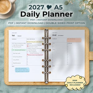 May include: A 2027 A5 daily planner with a six-ring metal binder mechanism. The open pages show schedules for January 1st and 2nd, including to-do lists and note sections. The text includes 2027 A5 Daily Planner, PDF, Instant Download, and 2026 Daily Planner Included.