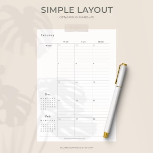 May include: A minimalist planner page with the text "SIMPLE LAYOUT" and "GENEROUS MARGINS". It features a January calendar, a December and February calendar, and a white pen with gold detailing. The website address is also visible.