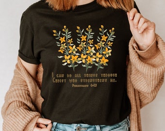 May include: Black t-shirt with a floral design and the text "I can do all things through Christ who strengthens me. Philippians 4:13"