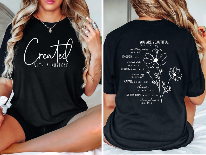 May include: Black t-shirt with white text that reads "Created with a purpose" on the front and "You are beautiful" with a list of encouraging words and bible verses on the back.