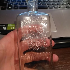 Old glass bottle with the inscription. * PHARMACIE *