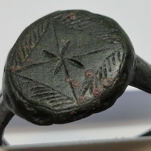 Ancient Roman bronze ring with an ornament.