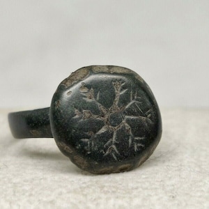 Ancient Roman bronze ring with an ornament.