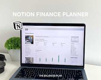 May include: A laptop computer displaying a Notion finance planner on the screen. The screen shows a financial dashboard with sections for accounts, savings goals, income, and expenses. The Notion logo is in the top left corner of the screen. The laptop is on a white surface.