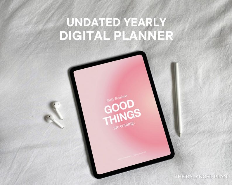 May include: A pink digital planner with the text "Daily Reminder: GOOD THINGS are coming" on a white bed with a white stylus and white earbuds.