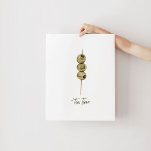 Art print with hand painted water color olives on a toothpick with the saying "tini time" in handwritten font