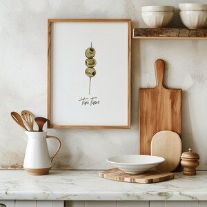 Art print with hand painted water color olives on a toothpick with the saying "tini time" in handwritten font