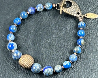 Lapis beaded bracelet with lost wax brass center piece bead, copper beads & hammered antique brass toggle clasp