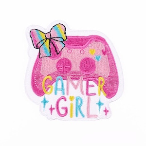 May include: Pink embroidered patch with a pink video game controller, a rainbow bow, and the text "Gamer Girl" with glitter accents.