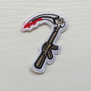 May include: White embroidered patch of a stylized scythe with a red blade and a brown handle.