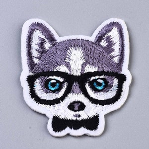 May include: Embroidered iron-on patch of a grey and white husky wearing blue-rimmed glasses and a black bow tie.