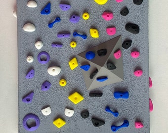 Mini Rock Wall: Various color 3D printed rocks on a textured grey wall to add some color to your walls!