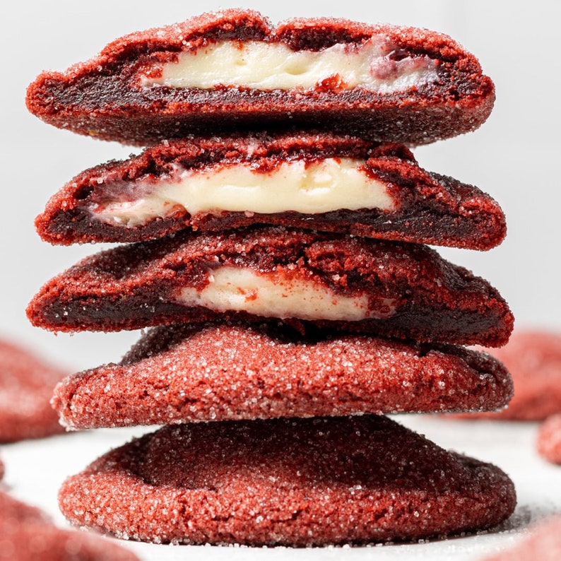 Five stuffed red velvet cookies in a stack.
