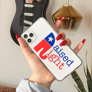 May include: A clear phone case with a red, white, and blue graphic of a star and the text "Raised Right".