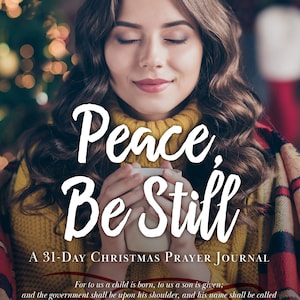 May include: A woman with her eyes closed is holding a white mug. She is wearing a yellow sweater and a red and black plaid blanket. The text "Peace, Be Still" is written in white cursive letters. The text "A 31-Day Christmas Prayer Journal" is written in white letters. The text "For to us a child is born, to us a son is given; and the government shall be upon his shoulder, and his name shall be called Wonderful Counselor, Mighty God, Everlasting Father, Prince of Peace. - Isaiah 9:6" is written in white letters.