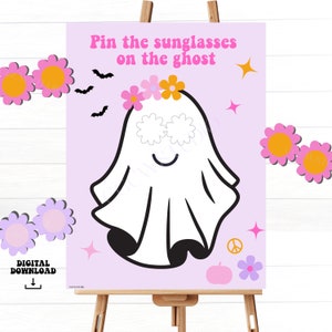 Puede incluir: Un juego imprimible "Pin the Sunglasses on the Ghost" con una linda ilustración de un fantasma con una corona de flores. El juego es perfecto para una fiesta de Halloween.
