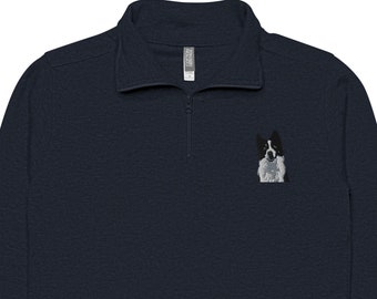 May include: A navy blue quarter-zip sweatshirt with an embroidered image of a black and white dog on the left chest.