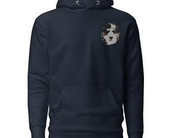 Può includere: Una felpa con cappuccio blu navy con una piccola immagine ricamata di un muso di cane sul petto sinistro.
