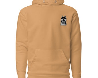 May include: A tan hoodie with a black and white husky dog embroidered on the front.