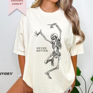Könnte beinhalten: Ein weißes T-Shirt mit einem schwarzen Skelett-Motiv und dem Text "NEVER BETTER".