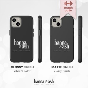 May include: Black phone cases with the "hanna & ash" logo in white. The cases are shown in glossy and matte finishes. The text "tough case" is above the phone case. The text "APPAREL - GIFTS - HOME DECOR" is below the logo.