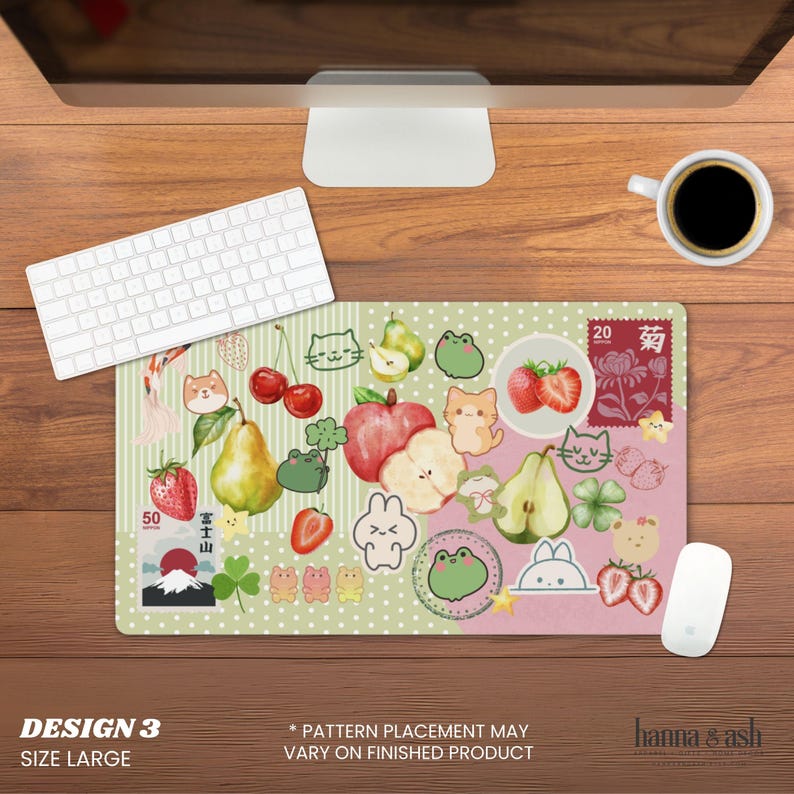May include: A large, rectangular mousepad with a whimsical design featuring cartoon fruits, animals, and Japanese-inspired elements. The design includes strawberries, pears, cats, frogs, and a stamp with Japanese text. The mousepad is on a wooden desk.