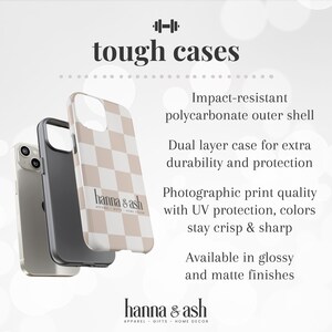 May include: Three phone cases, one silver, one black, and one with a tan and white checkered pattern. The text "tough cases" is at the top, with "hanna & ash" below. The cases are impact-resistant with a dual-layer design.