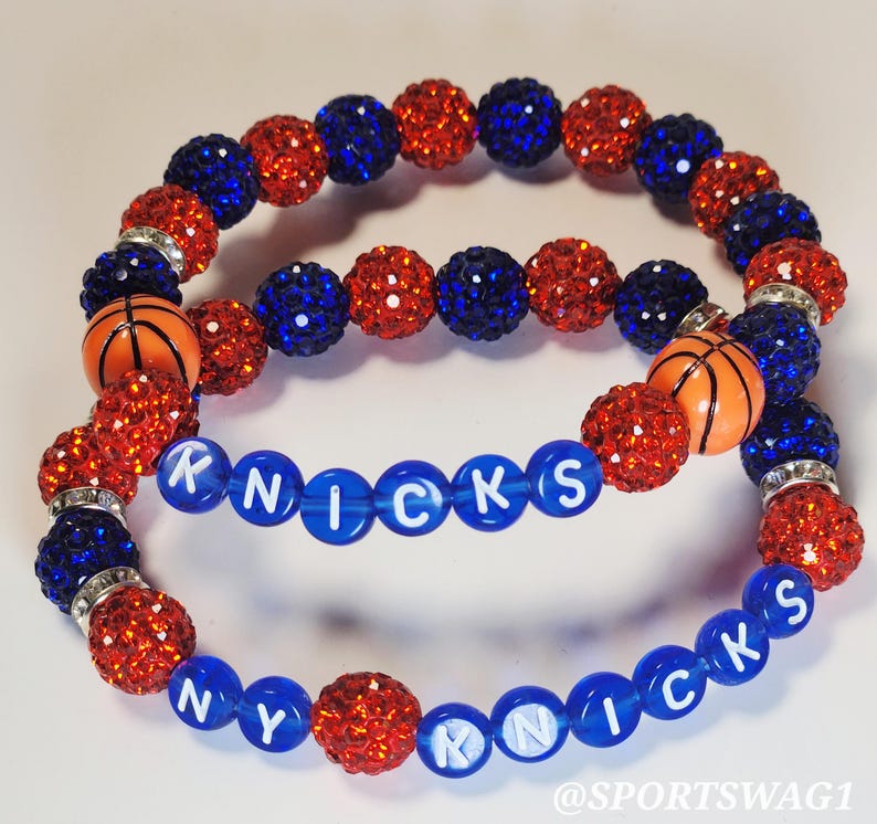 Handmade sparkly bracelet set featuring orange and blue crystal-encrusted beads with mini basketball charms and "NY KNICKS" letter beads, designed for fans of the New York Knicks basketball team perfect for game day, team spirit, and gifting. Custom colors available.