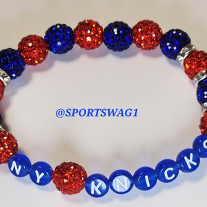 Handmade sparkly bracelet set featuring orange and blue crystal-encrusted beads with mini basketball charms and "NY KNICKS" letter beads, designed for fans of the New York Knicks basketball team perfect for game day, team spirit, and gifting. Custom colors available.