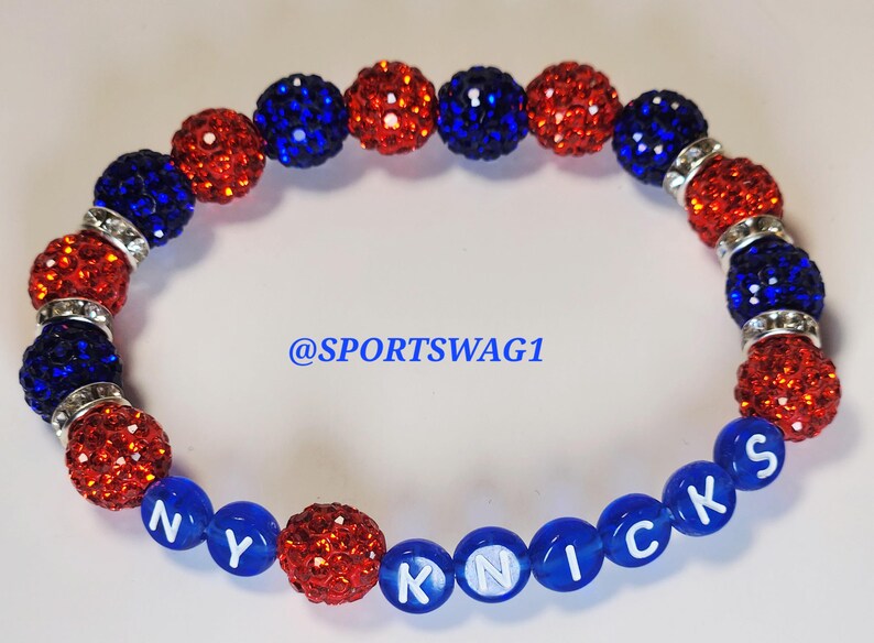 Handmade sparkly bracelet set featuring orange and blue crystal-encrusted beads with mini basketball charms and "NY KNICKS" letter beads, designed for fans of the New York Knicks basketball team perfect for game day, team spirit, and gifting. Custom colors available.