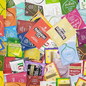 May include: A selection of tea bags from brands such as Pukka, Twinings, and Yorkshire Tea. The tea bags are in various colours, with labels indicating the tea type, including "Earl Grey" and "Mint Matcha Green".