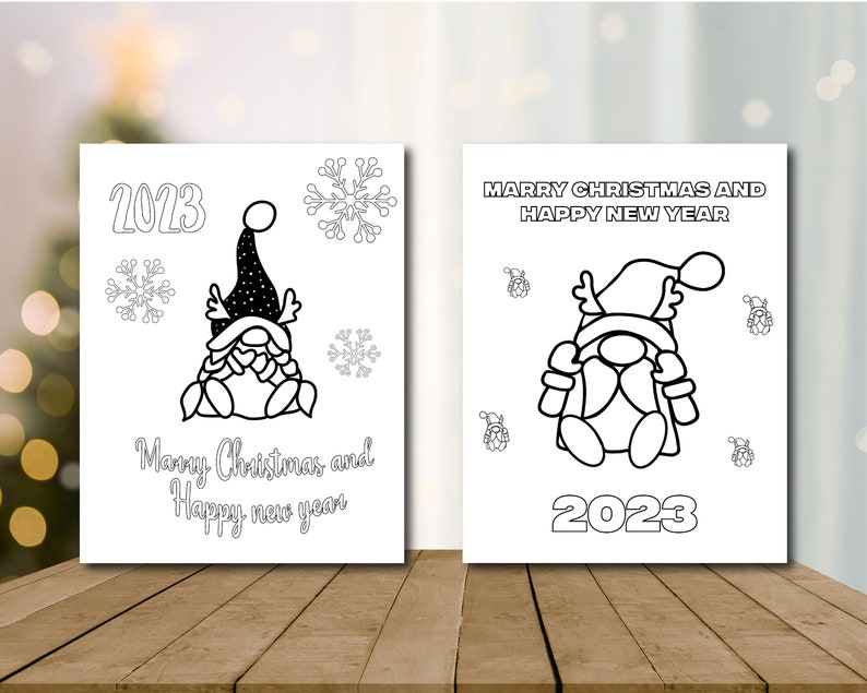 May include: Two black and white printable coloring pages featuring a gnome with a hat and the text "Merry Christmas and Happy New Year" and "2023".