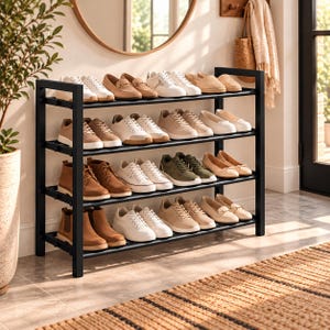 May include: A four-tier black metal shoe rack holding various styles of footwear, including sneakers, loafers, boots, and flats in neutral shades of white, beige, tan, and olive green, arranged neatly across the horizontal shelves.