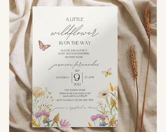 Può includere: Un invito bianco con un design floreale e farfalle. Il testo recita "A little wildflower is on the way" e include il nome "Jomine Fernandez" e la data "September 9, 2023".