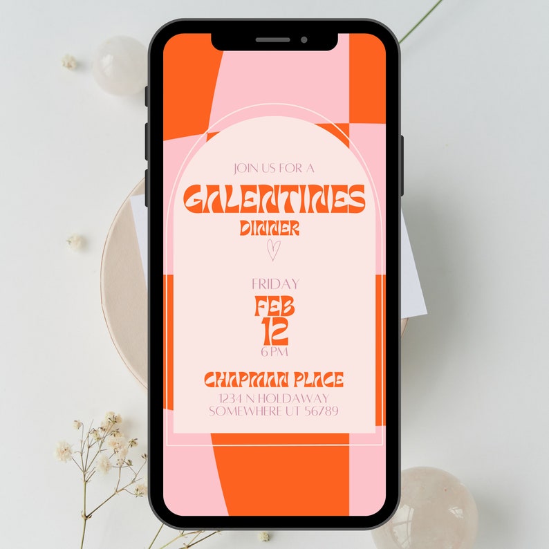 May include: A mobile phone screen displaying a digital invitation for a Galentine's Dinner on Friday, February 12th at 6 PM. The invitation is in a pink and orange color scheme with a geometric pattern. The event is being held at Chapman Place, 1234 N Holdaway, Somewhere UT 56789.