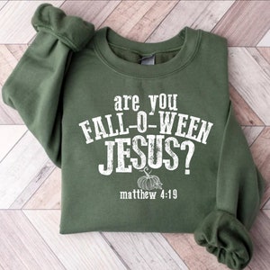 May include: Green sweatshirt with white text that reads "Are you Fall-o-Ween Jesus? Matthew 4:19" with a white pumpkin graphic.