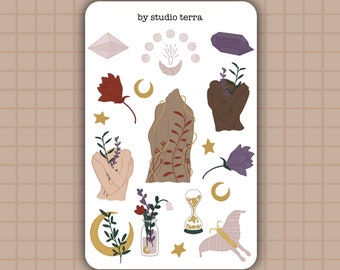 May include: A sheet of stickers with a variety of designs, including crystals, moons, flowers, and a person with their arms crossed. The text "by studio terra" is at the top of the sheet.