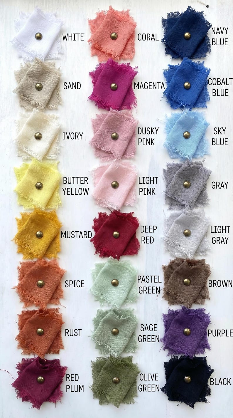 May include: A color chart featuring samples of fabric in various shades, including white, coral, navy blue, sand, magenta, and others. Each fabric swatch is adorned with a gold-colored stud and labeled with its corresponding color name.