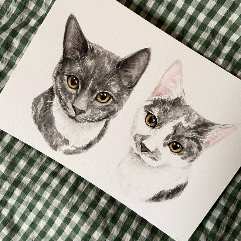 May include: Watercolor painting of two cats. One cat is gray with white markings and the other is white with gray markings. Both cats have orange eyes.