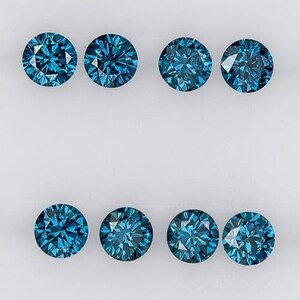May include: Eight round blue diamonds on a white background.