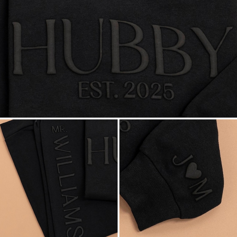 May include: Black sweatshirt with the text "HUBBY EST. 2025" on the front and "MR. WILLIAMS" on the side. The sleeve has the text "J&M" with a heart symbol.